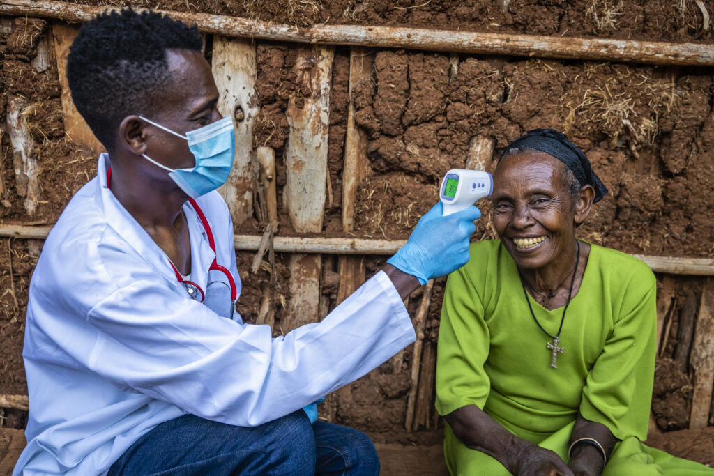 Doctor measuring body temperature with digital thermometer, East Africa